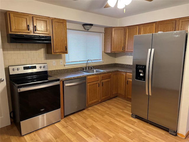 kitchen featuring sink, backsplash, light hardwood / wood-style flooring, and stainless steel appliances