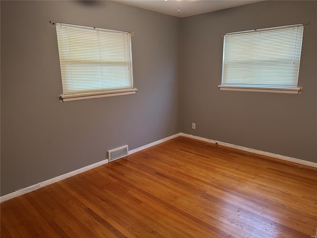 spare room with light hardwood / wood-style flooring