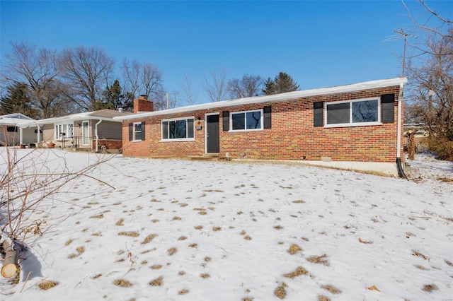 ranch-style house with brick siding and a chimney