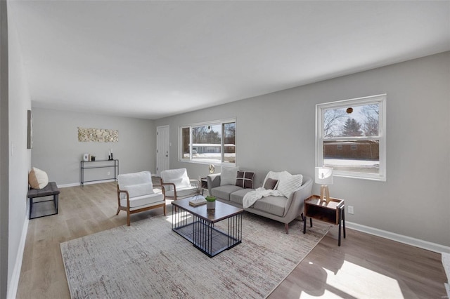 living room with light wood-style flooring and baseboards