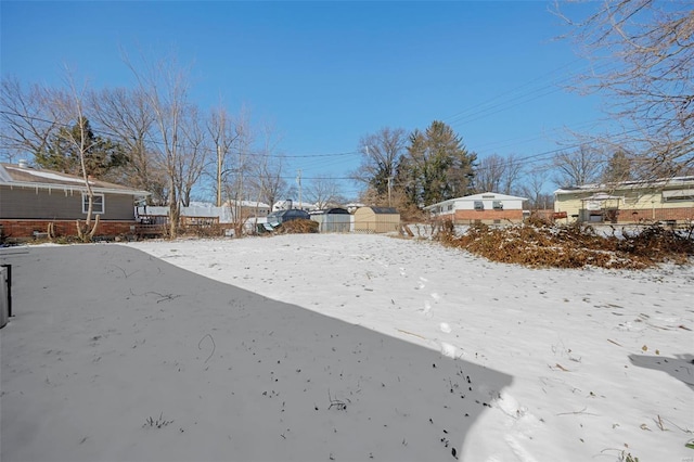 view of yard layered in snow