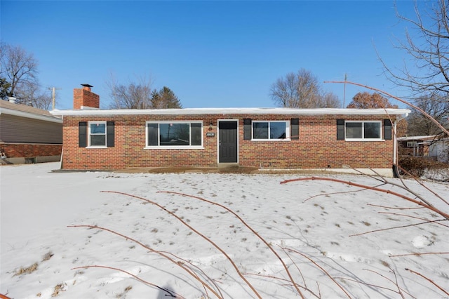 view of front of property with brick siding and a chimney