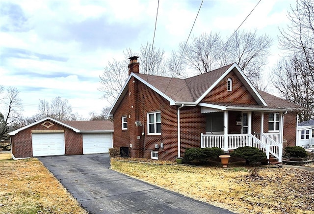 view of front of home with a garage, a front lawn, and covered porch