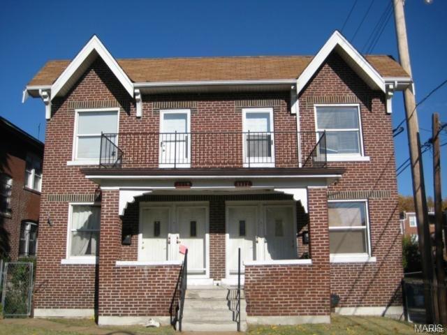 multi unit property featuring a balcony and covered porch