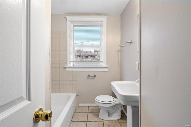 full bath featuring baseboards, toilet, and tile patterned floors