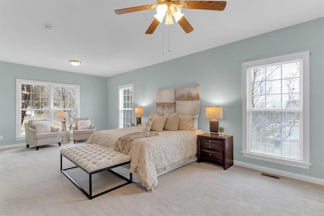 bedroom featuring light carpet and ceiling fan