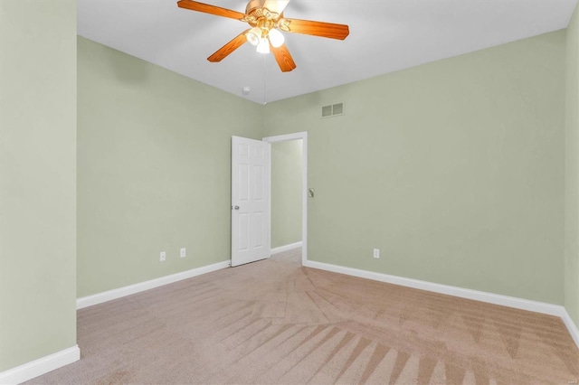 spare room with light carpet and ceiling fan