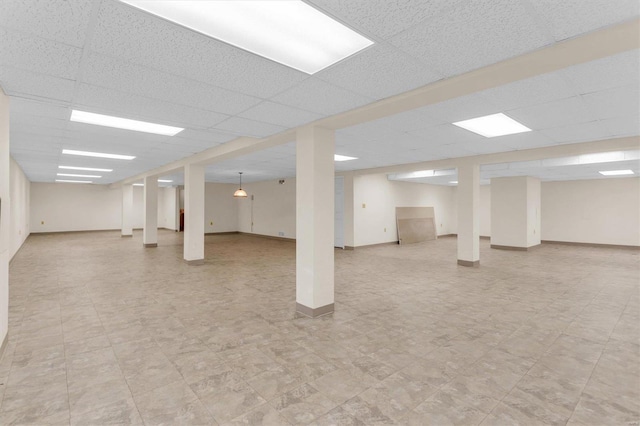 basement with a paneled ceiling