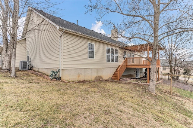 rear view of property with a wooden deck, a lawn, and central air condition unit