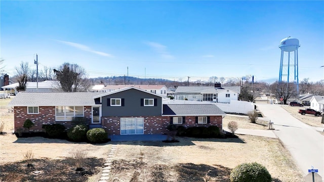 split level home with brick siding and a residential view