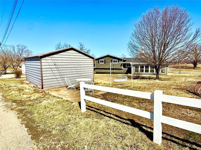 exterior space featuring an outbuilding and fence