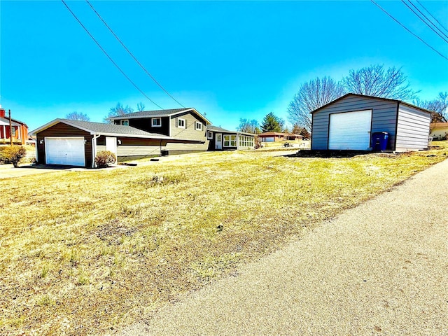 view of yard featuring an outbuilding and a detached garage