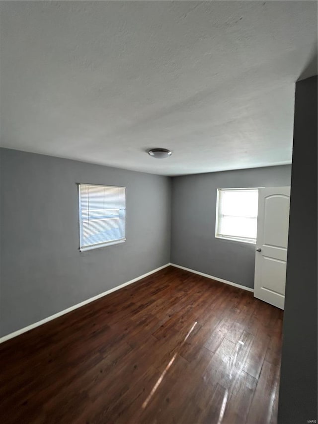 spare room featuring dark hardwood / wood-style floors