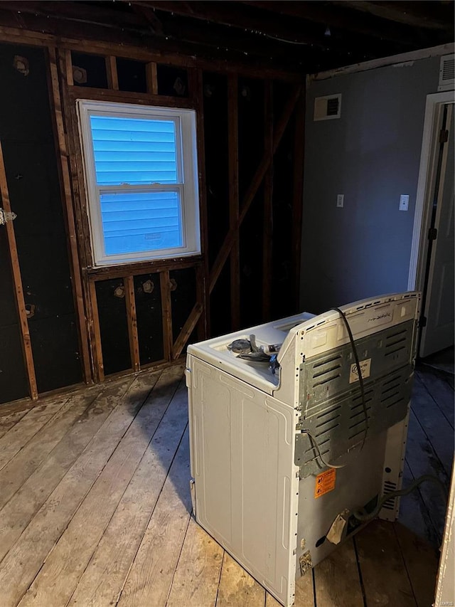 misc room featuring light wood-style flooring and visible vents