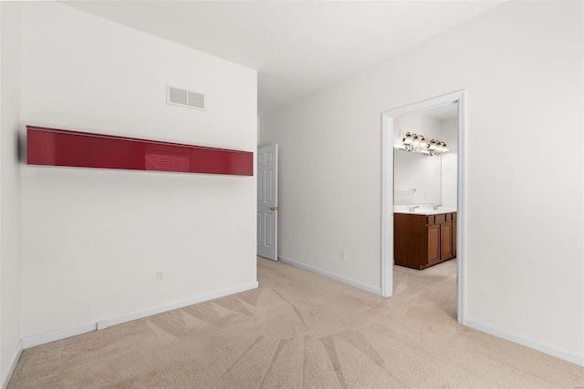 spare room with light carpet, baseboards, and visible vents