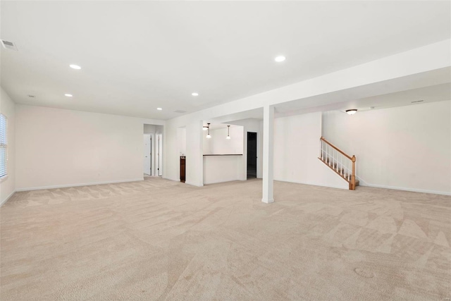 interior space featuring light carpet, stairs, baseboards, and recessed lighting