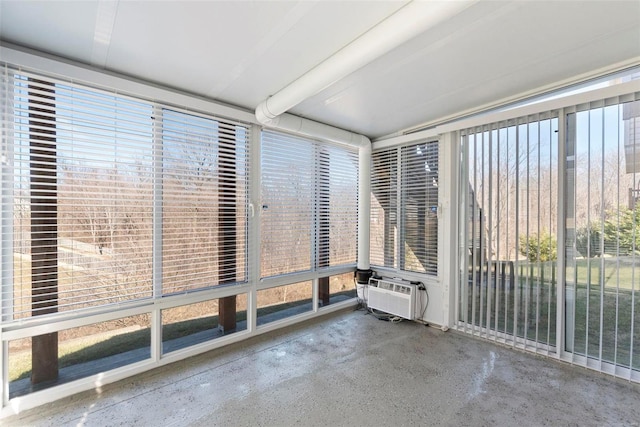 unfurnished sunroom with a wall unit AC