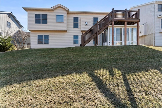 rear view of house with a deck, a yard, and stairway