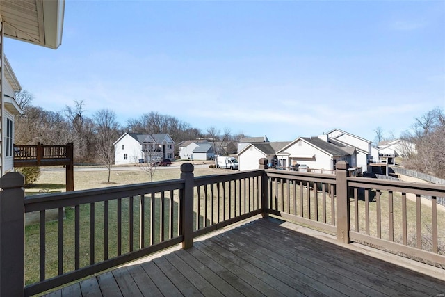 deck featuring a residential view and a yard