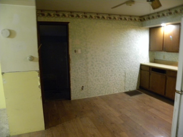 kitchen with ceiling fan and light hardwood / wood-style floors