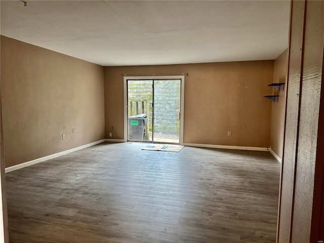 unfurnished room featuring dark hardwood / wood-style flooring