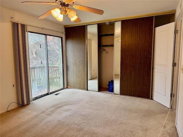 unfurnished bedroom featuring access to outside, light carpet, ceiling fan, and a closet