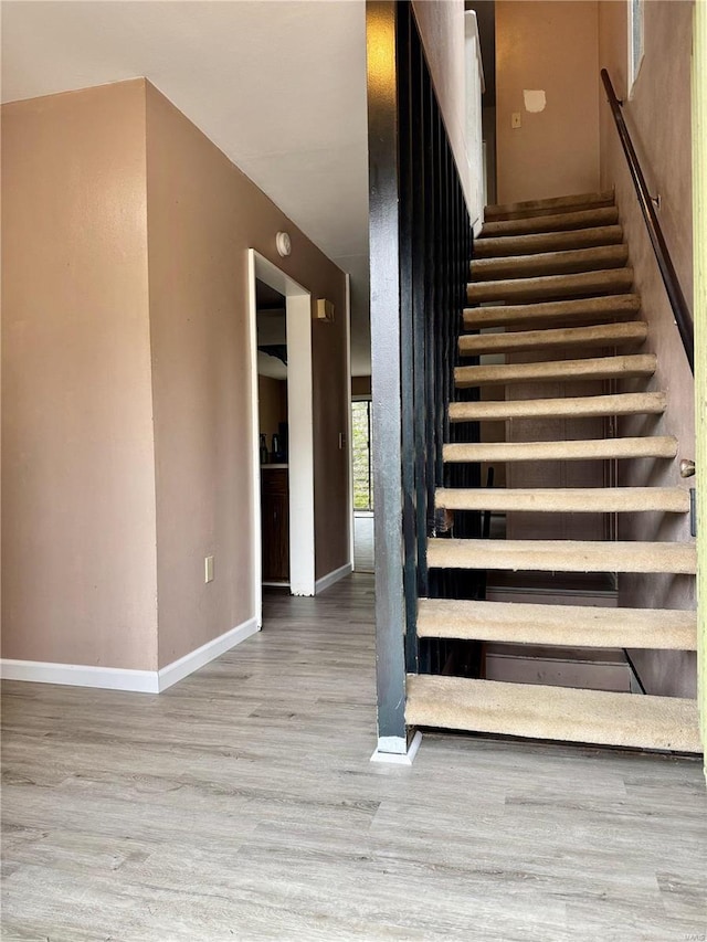 stairs with wood-type flooring