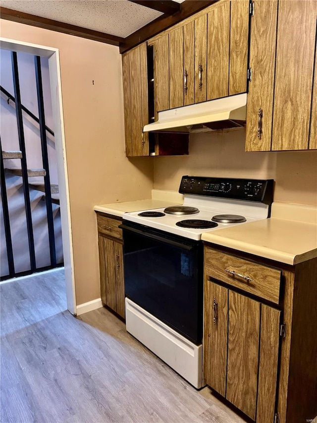 kitchen with electric range and light hardwood / wood-style floors