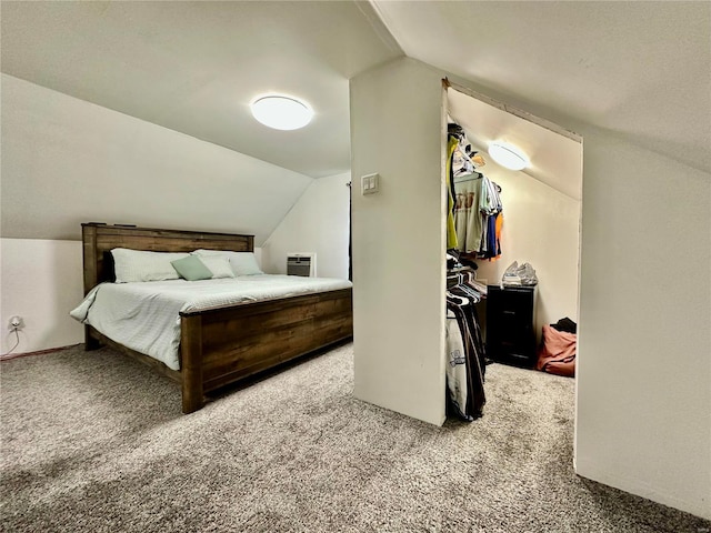 carpeted bedroom with lofted ceiling and a spacious closet