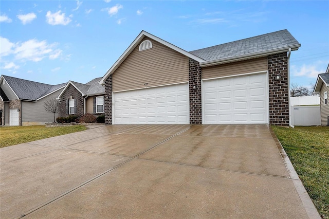 view of front facade with a garage and a front lawn