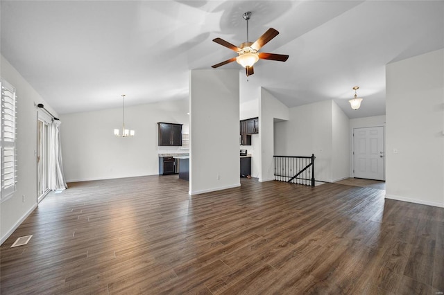 unfurnished living room featuring ceiling fan with notable chandelier, dark wood-type flooring, and high vaulted ceiling