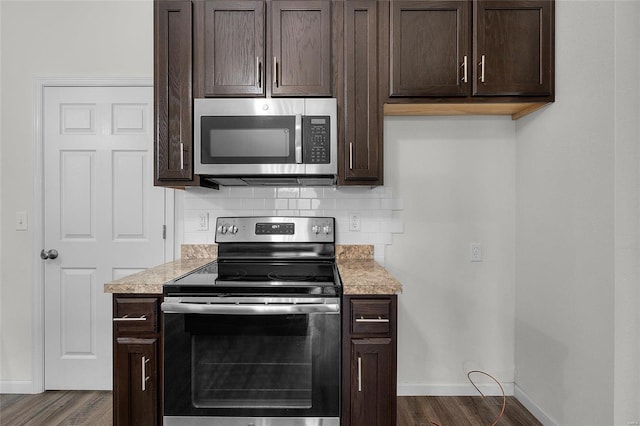 kitchen featuring decorative backsplash, dark brown cabinets, and stainless steel appliances