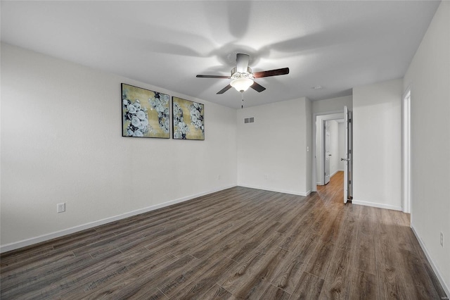 empty room featuring ceiling fan and dark hardwood / wood-style flooring