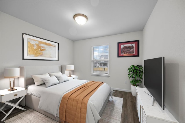 bedroom with dark hardwood / wood-style floors