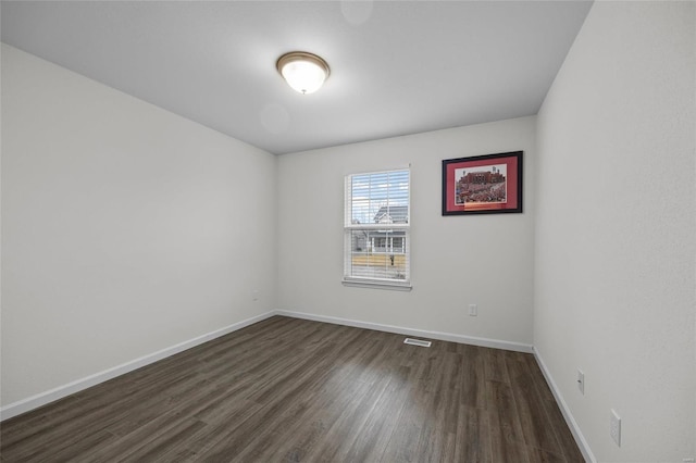 spare room with dark hardwood / wood-style flooring