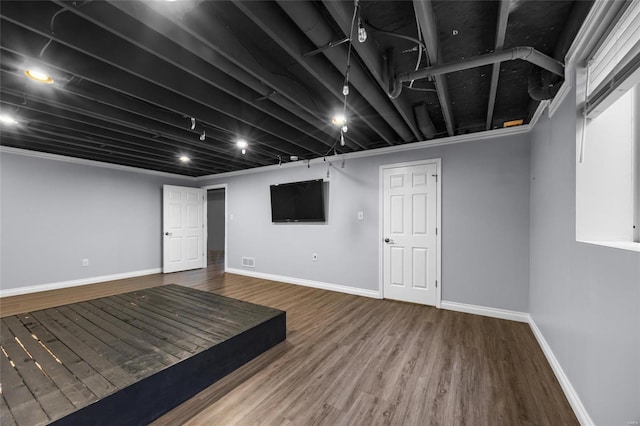 basement with hardwood / wood-style flooring