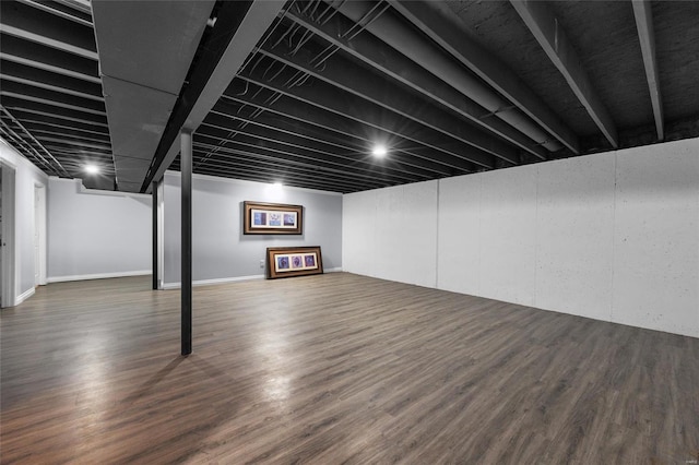 basement featuring dark hardwood / wood-style flooring