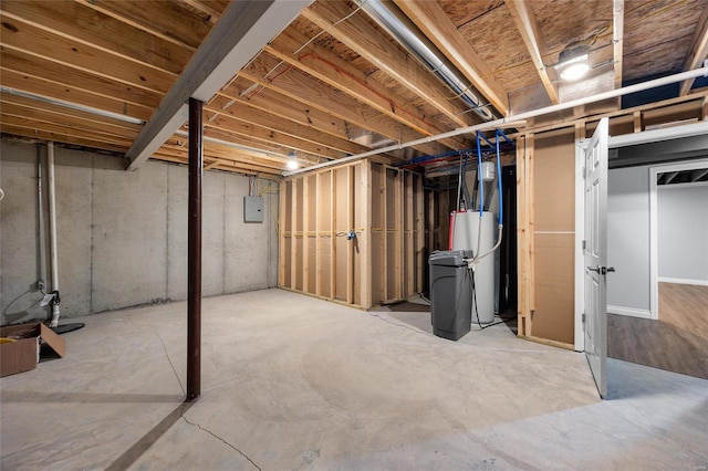 basement featuring electric panel and water heater