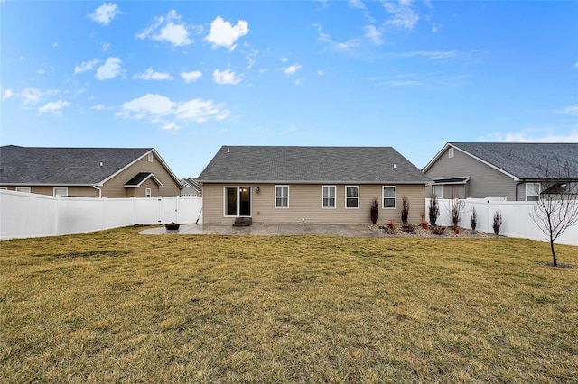 back of property with a yard and a patio area