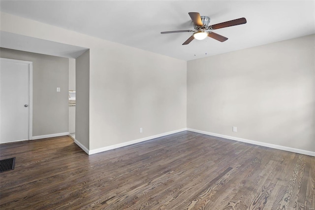 spare room with dark wood-type flooring and ceiling fan