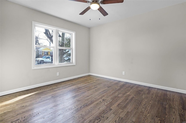 empty room featuring dark wood-type flooring and ceiling fan