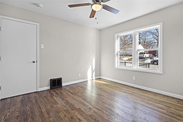 spare room with ceiling fan and dark hardwood / wood-style flooring