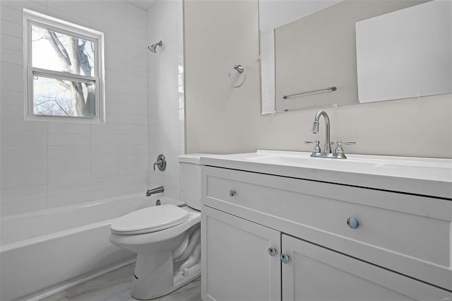 full bathroom featuring tiled shower / bath combo, vanity, and toilet