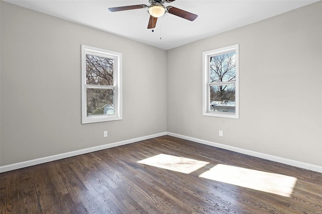 spare room featuring plenty of natural light, dark hardwood / wood-style floors, and ceiling fan