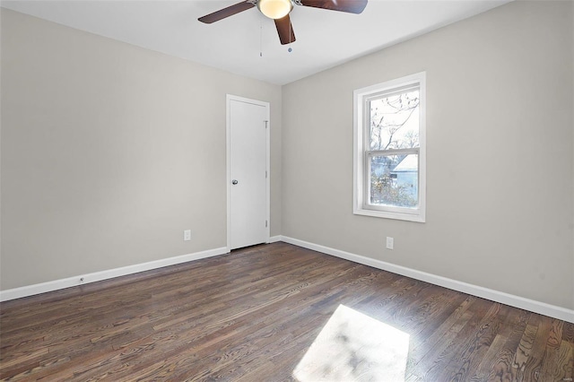 empty room featuring ceiling fan and dark hardwood / wood-style flooring