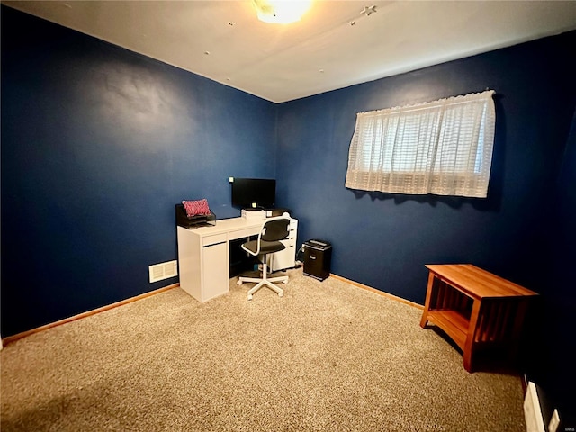 carpeted office space featuring baseboard heating