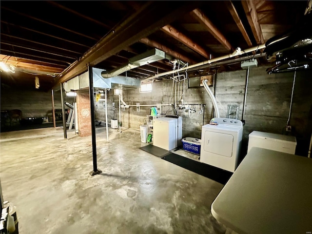 basement with fridge and washer and dryer