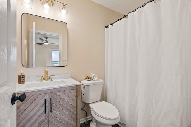 bathroom featuring vanity, toilet, and curtained shower