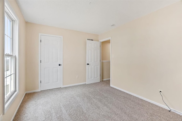 unfurnished bedroom featuring carpet flooring