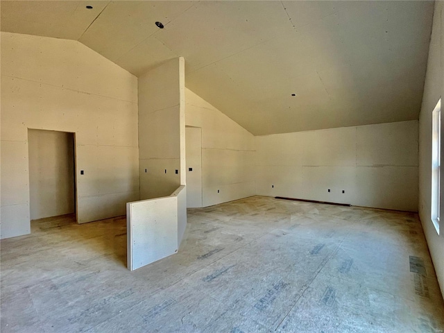 additional living space featuring vaulted ceiling